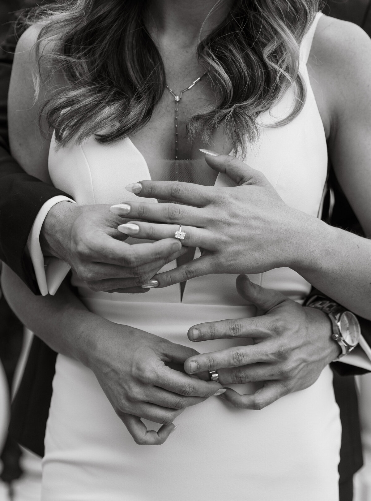 Wedding Photographer & Videographer, black and white image of husband and wife holding their rings