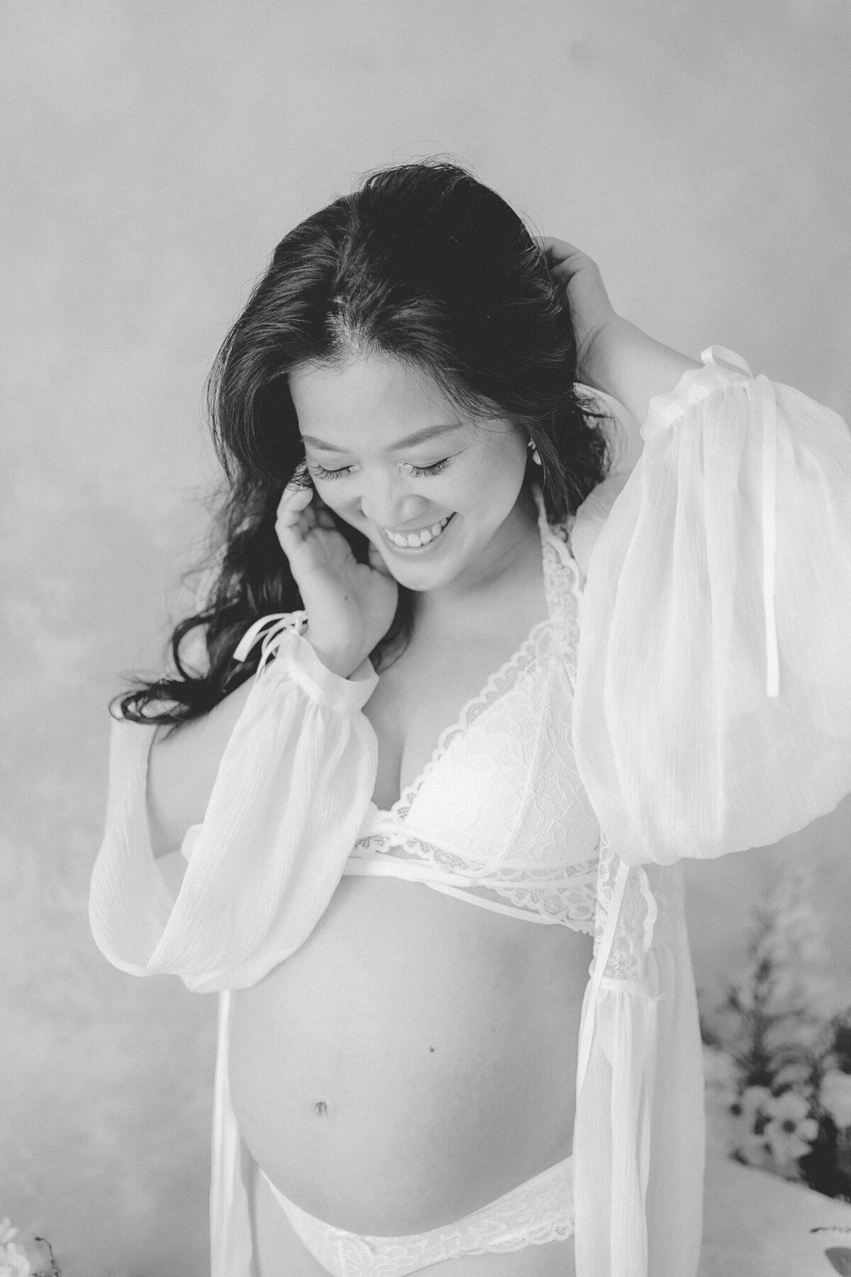 Radiate in the grace of motherhood as a mum showcases her pregnancy glow in a tulle gown at Gold Coast's natural light studio.