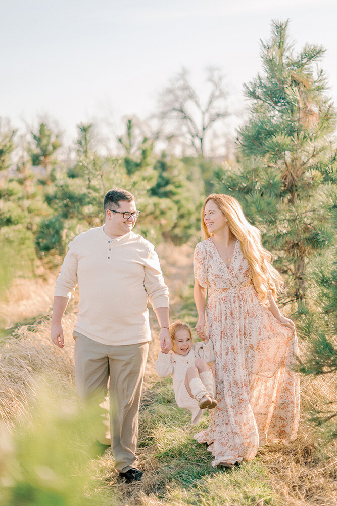 Family walking through a Christmas tree farm for their Christmas photos