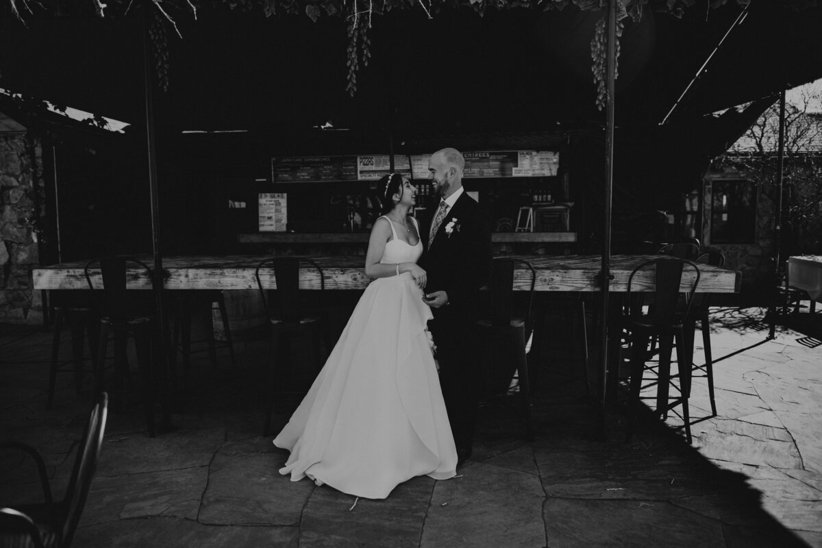 bride and groom standing together at a brewery in Santa Fe