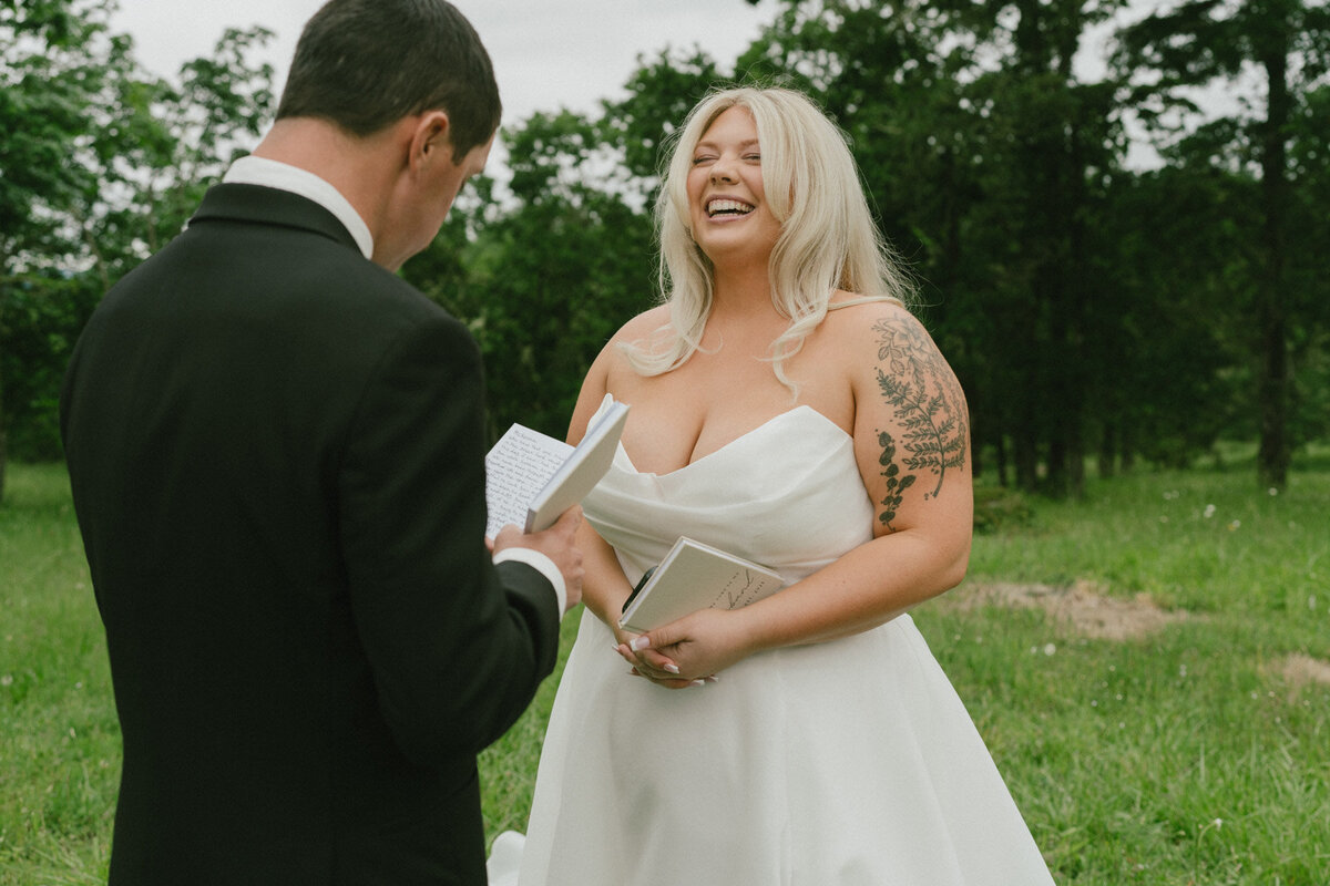 A bride and groom standing outdoors, representing bridal makeup done by Looks with Libby.