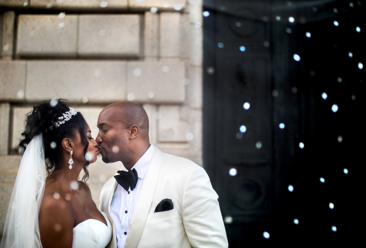 A black couple kisses in the front of the Old Courthouse in Cleveland.