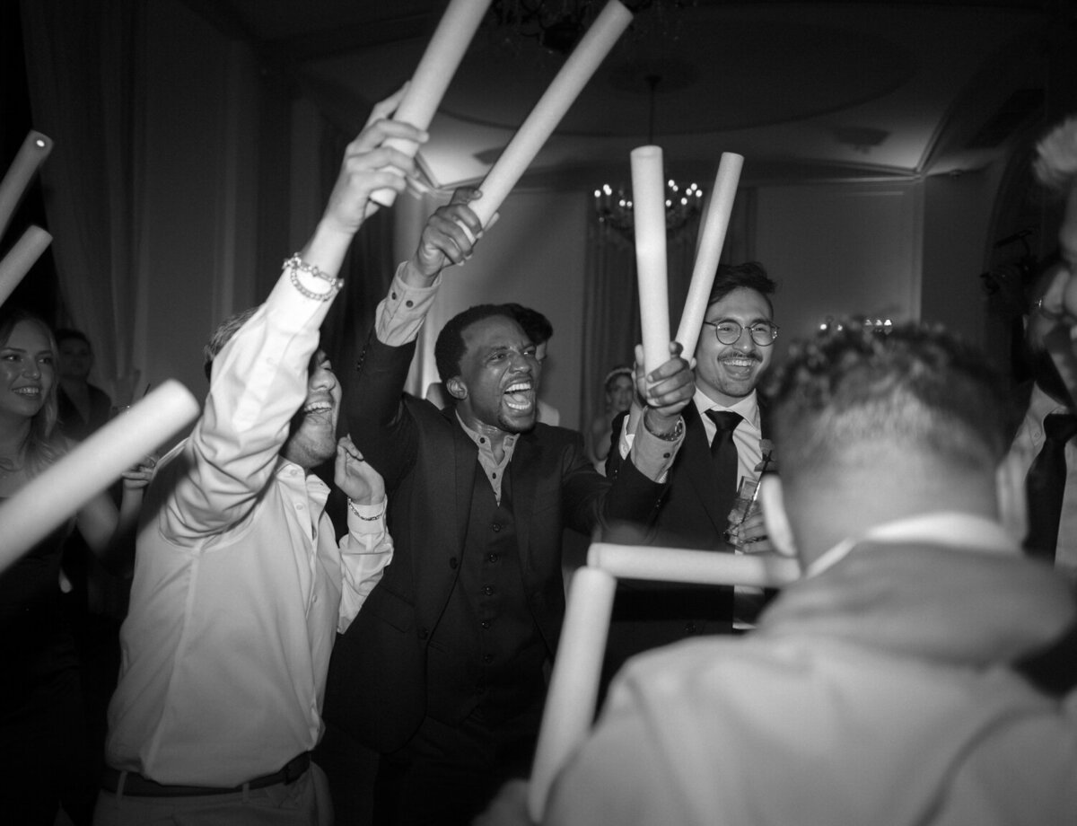 Guests cheer on the dance floor during a Colony Club Detroit wedding reception