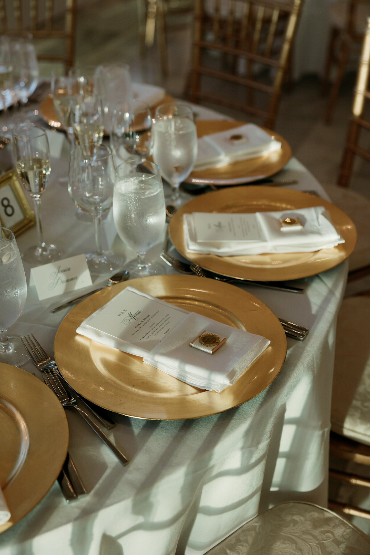 Elegant gold-rimmed place settings and menus photographed by Philadelphia wedding photographer.