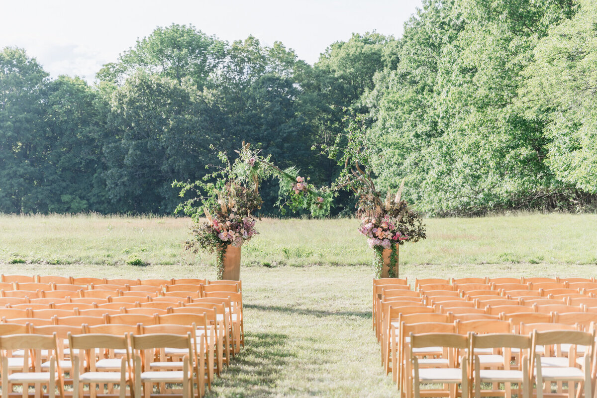 A whimsical floral arch sets the stage for a romantic garden wedding