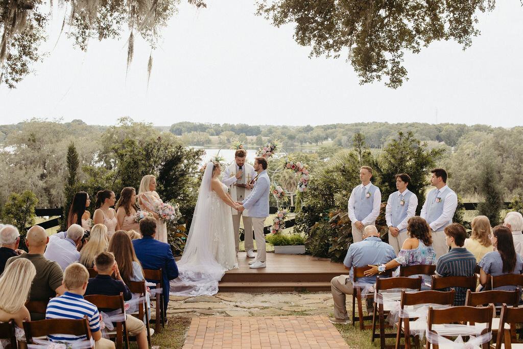 bride and groom exchanging vows  during wedding ceremony at Lakeview Gardens