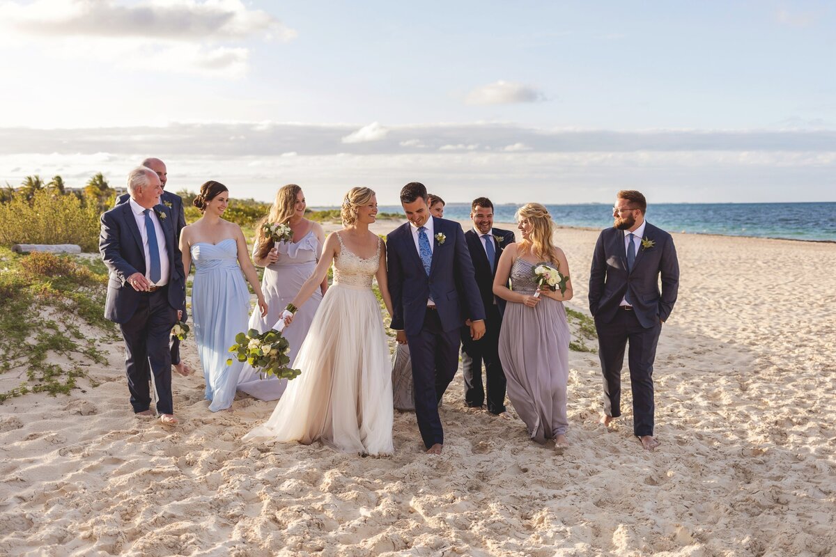Bridal party walking on beach in cancun