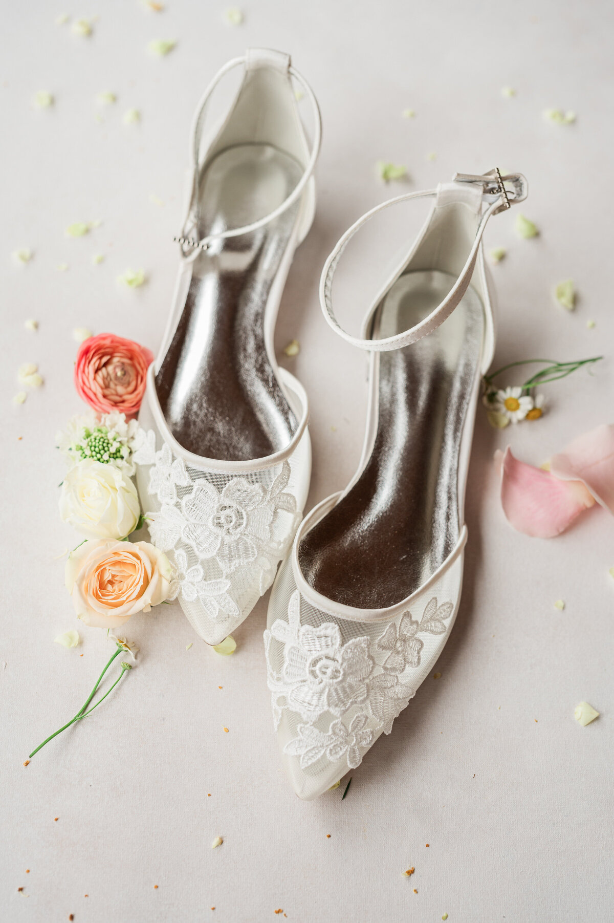 White heels with small flowers laid around them