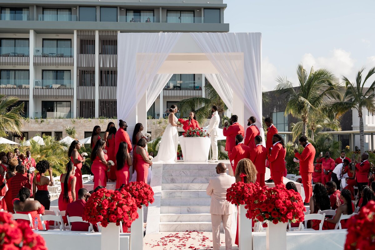 A red wedding ceremony with people dressed in red.