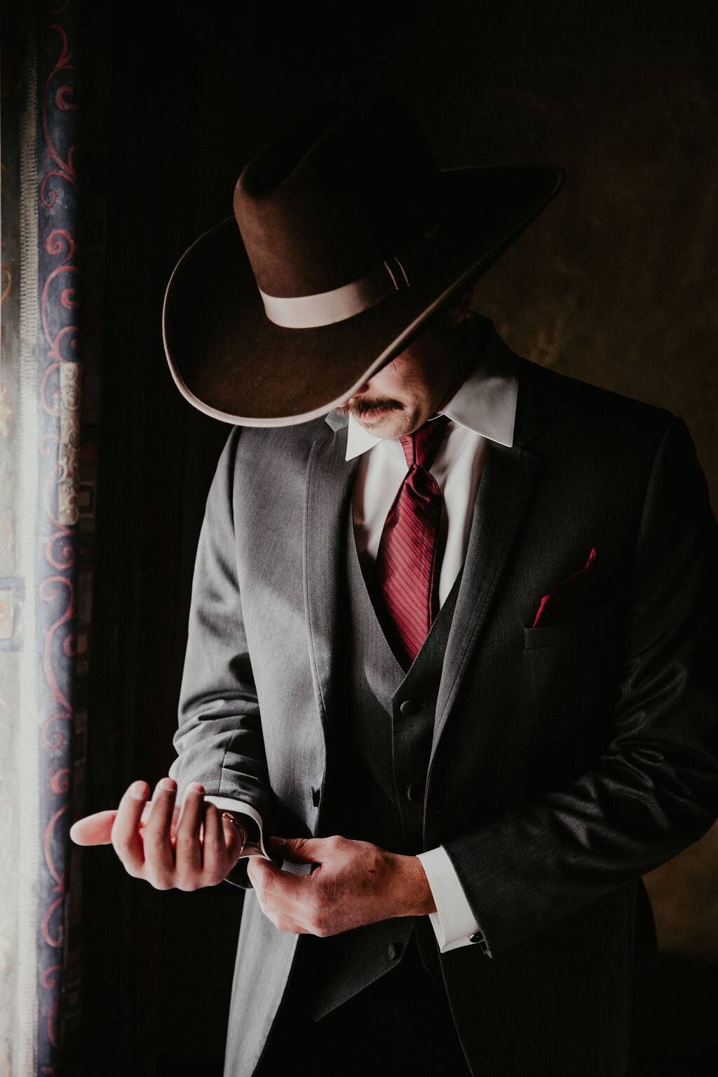 A groom checks his cufflinks