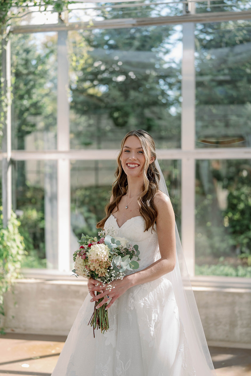 Soft, romantic headshot of the bride inside the Ivy House greenhouse.