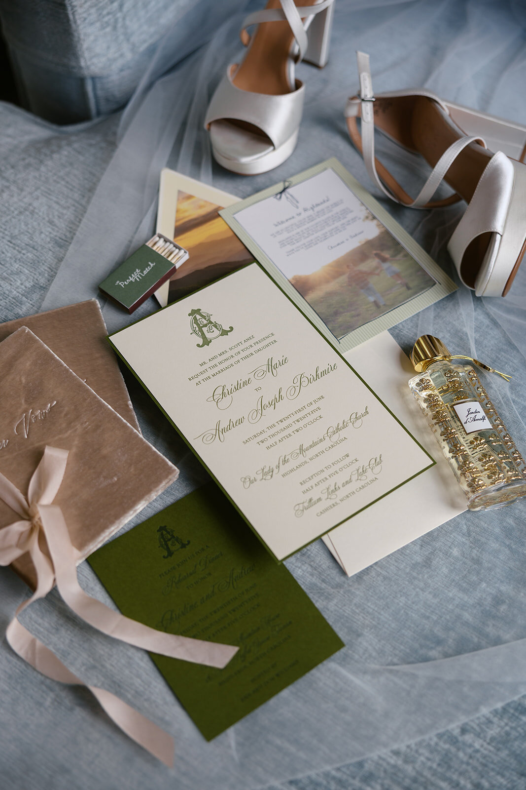 Wedding invitation suite with rings, shoes, and luxury perfume styled for detail photos in Highlands, North Carolina.