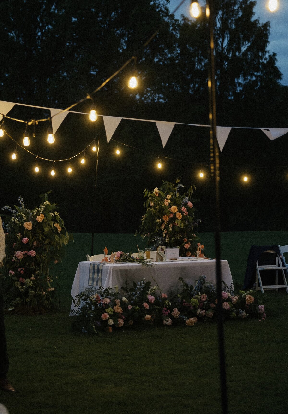 Wedding sweetheart table with colorful floral arrangements designed by Abby Grace Florals at Dahlonega GA wedding