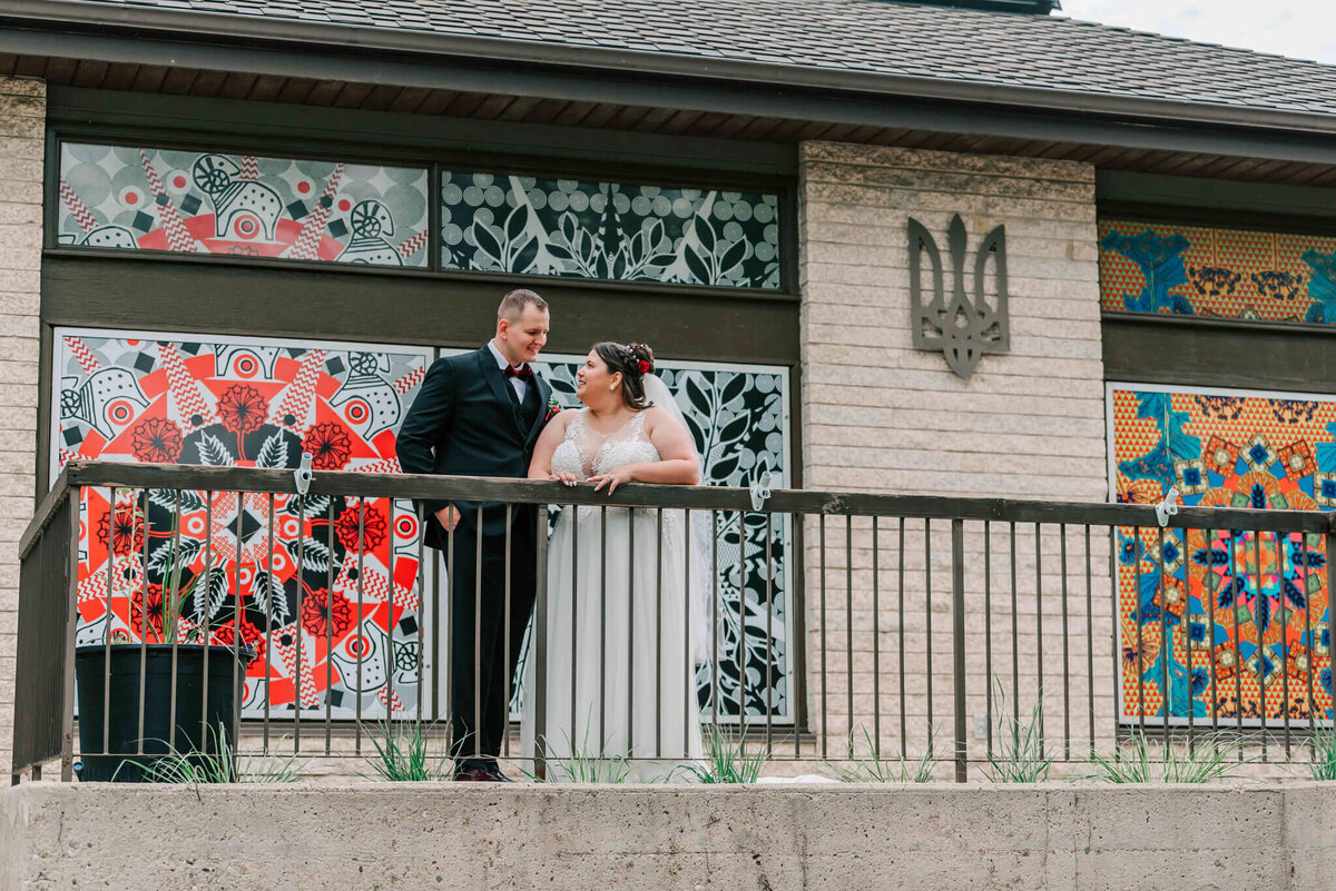 Bride and groom standing in front of the Ukrainian Museum.