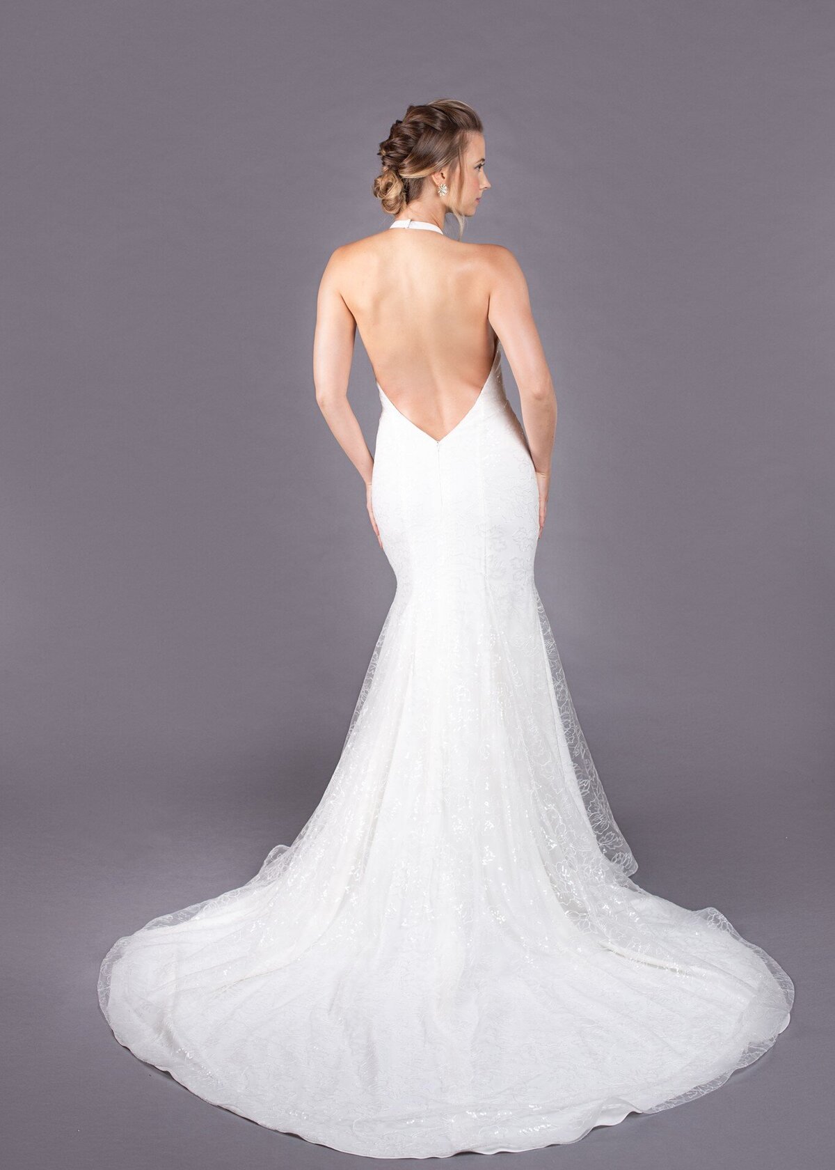 The halter neckline turns into a low open back on the Marlene wedding dress style, which leads into the train.