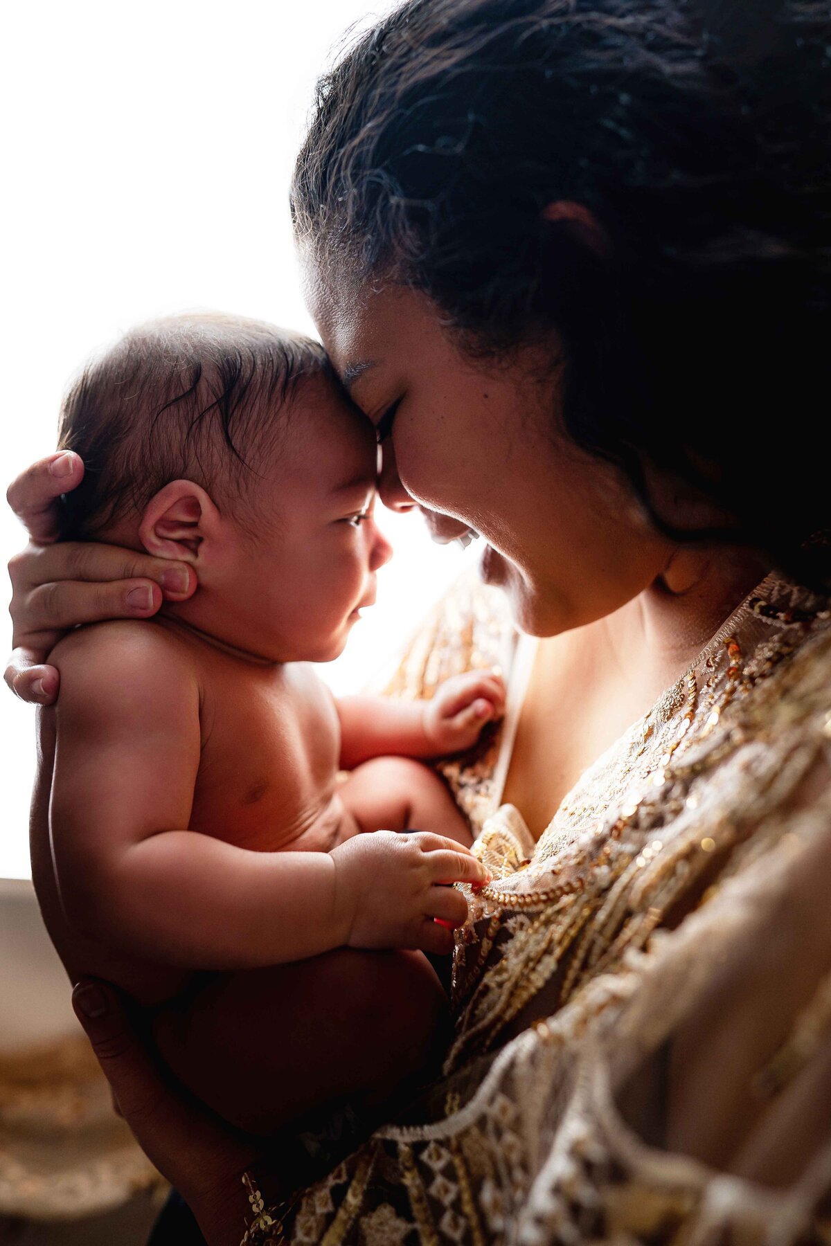 Mom Snuggles Newborn in Lifestyle Studio Tacoma