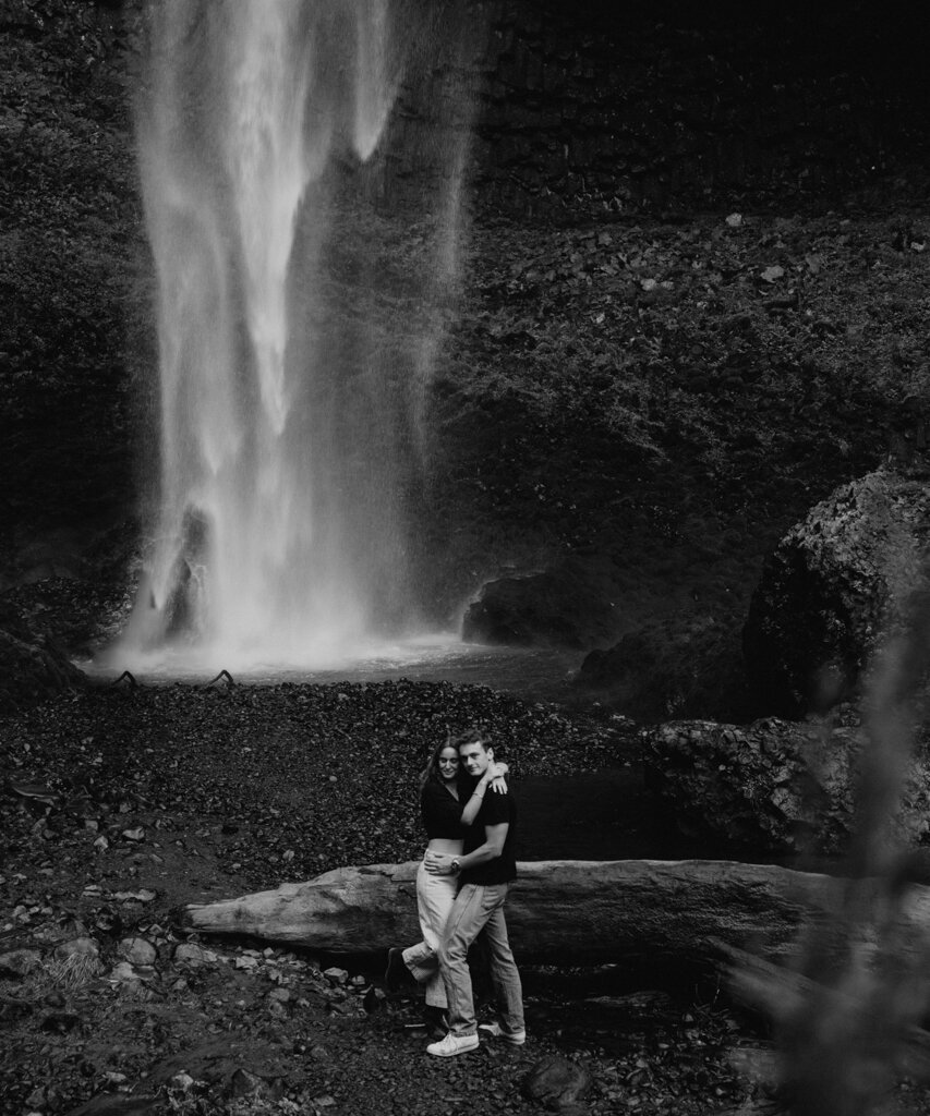 Couple hugging in front of waterfall, by Ninth Avenue Studios, authentic and intimate wedding photographer in Calgary, Saskatoon, and Vancouver. Featured on the Bronte Bride Vendor Guide.