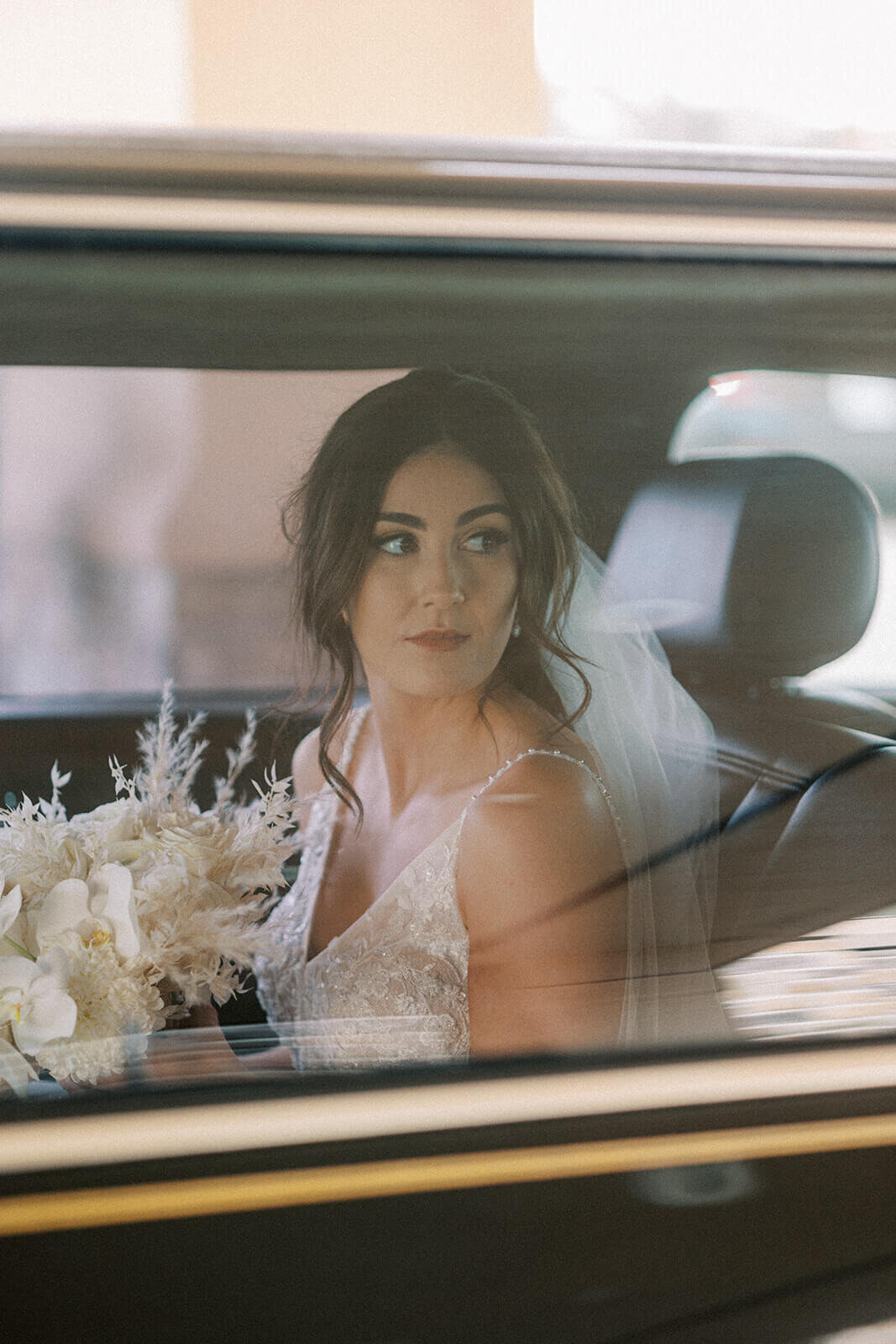 bride-in-car-with-bouquet