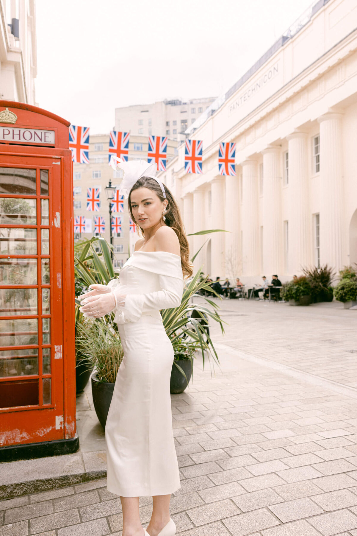 A wedding photo of the bride in her white wedding dress holding her white bouquet of flowers in London