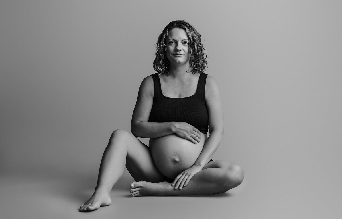 Expectant mother poses for fine art studio maternity portraits in Asheville, NC.