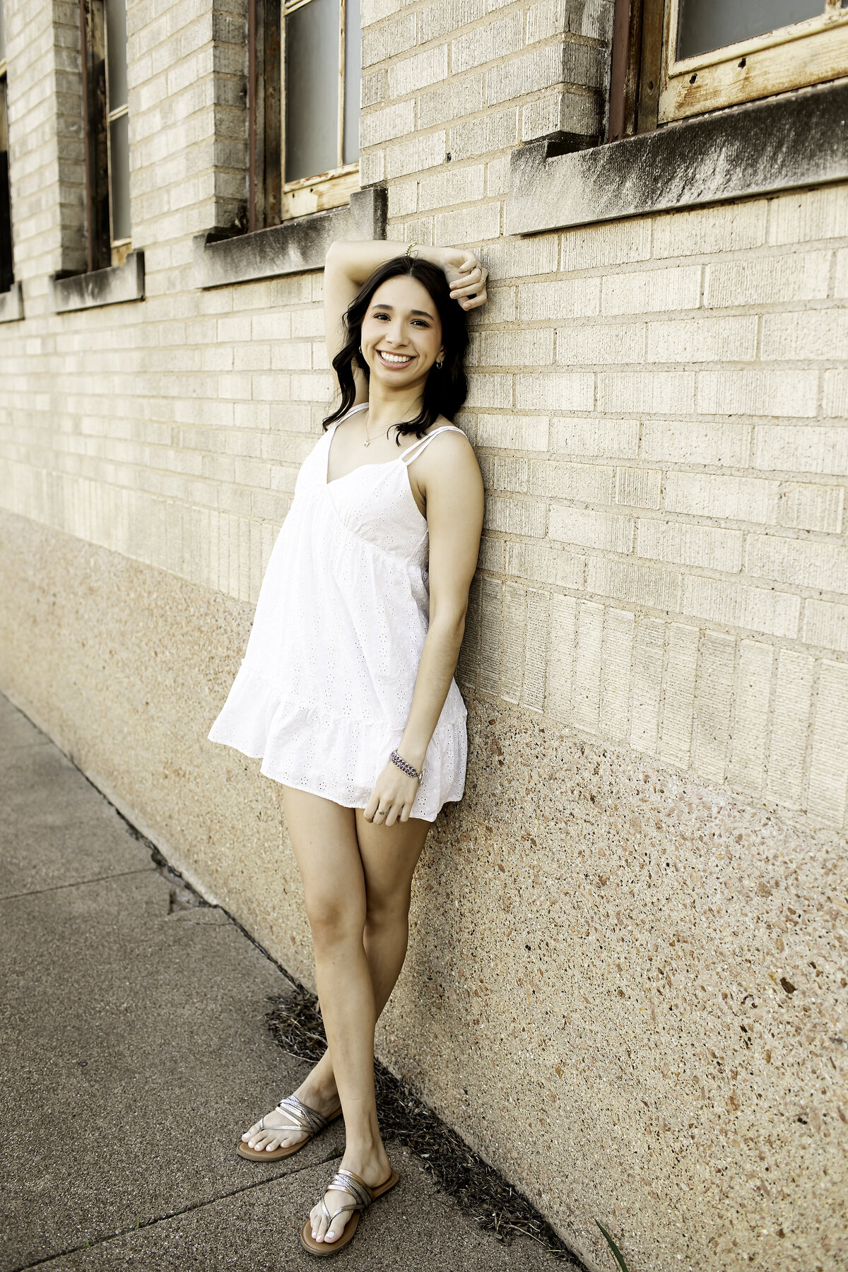 A high school senior rocking a trendy outfit against a sleek urban backdrop, combining modern style with the energy of the city for a memorable photoshoot