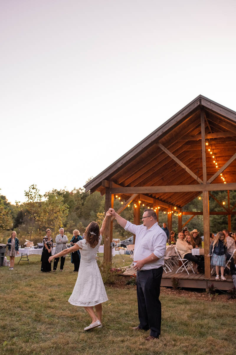 Bride and groom share their first dance together at their outdoor reception