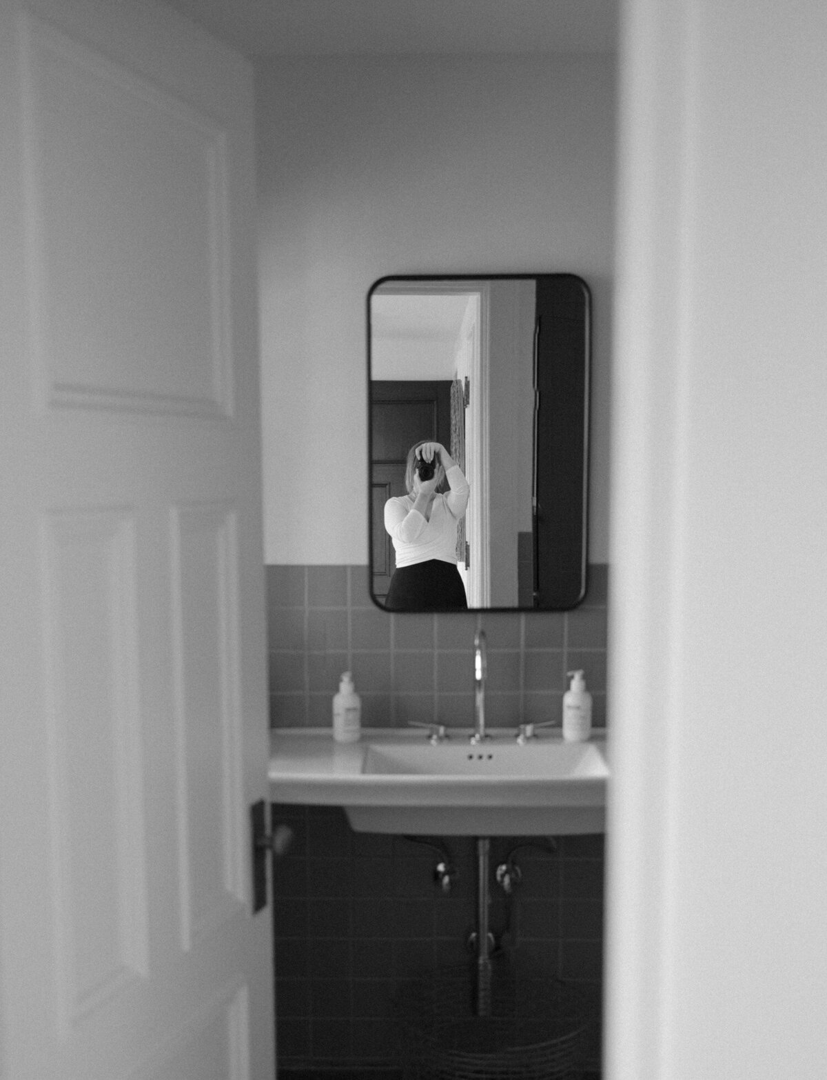 photographer reflection in mirror, interior photography, bathroom design at ALEO Detroit