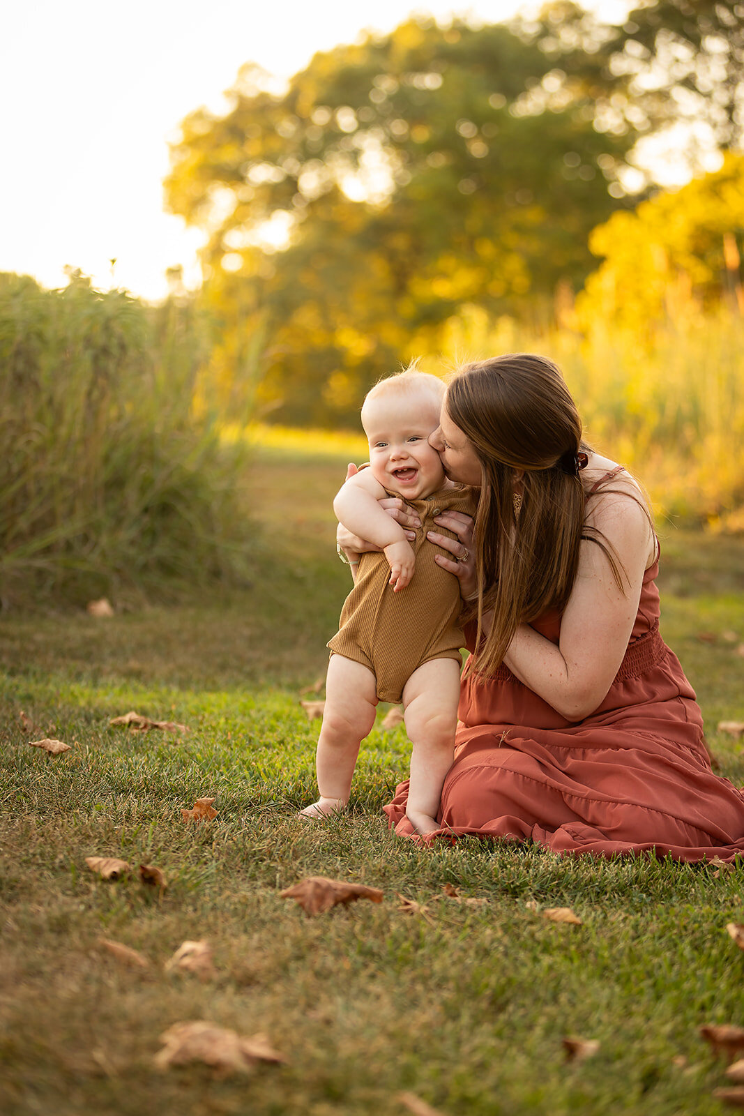 mom hugging and kissing baby