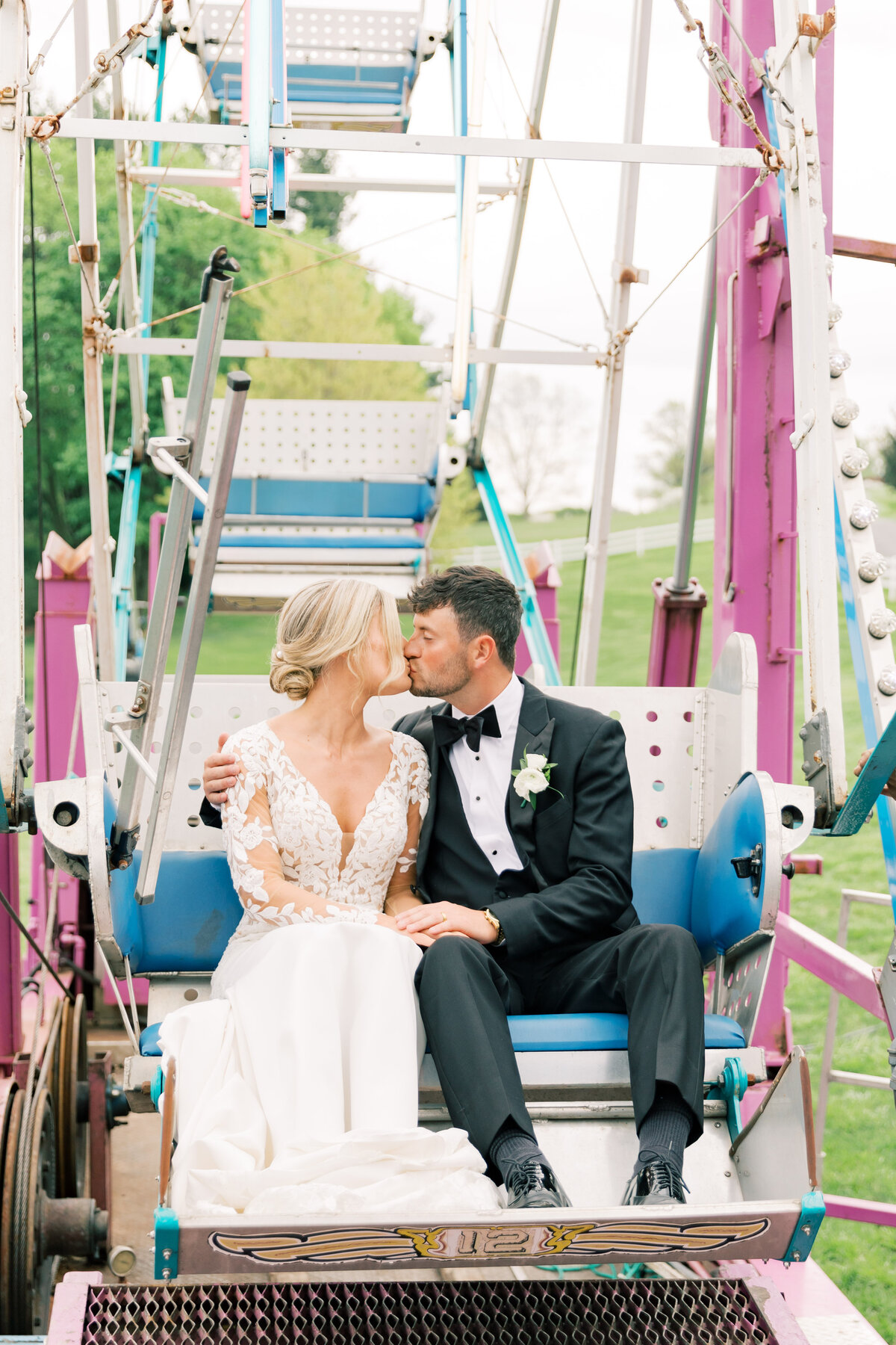 Bluestone Estate wedding couple sitting on a ferris wheel, capturing a fun and romantic moment at their wedding.