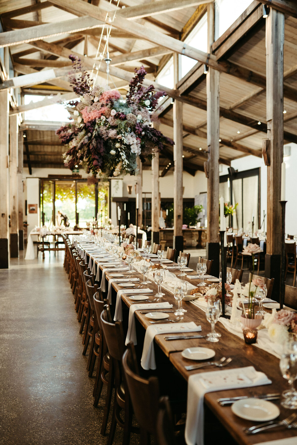 Large hanging floral installation at Stones of the Yarra Valley with massed moody toned blooms