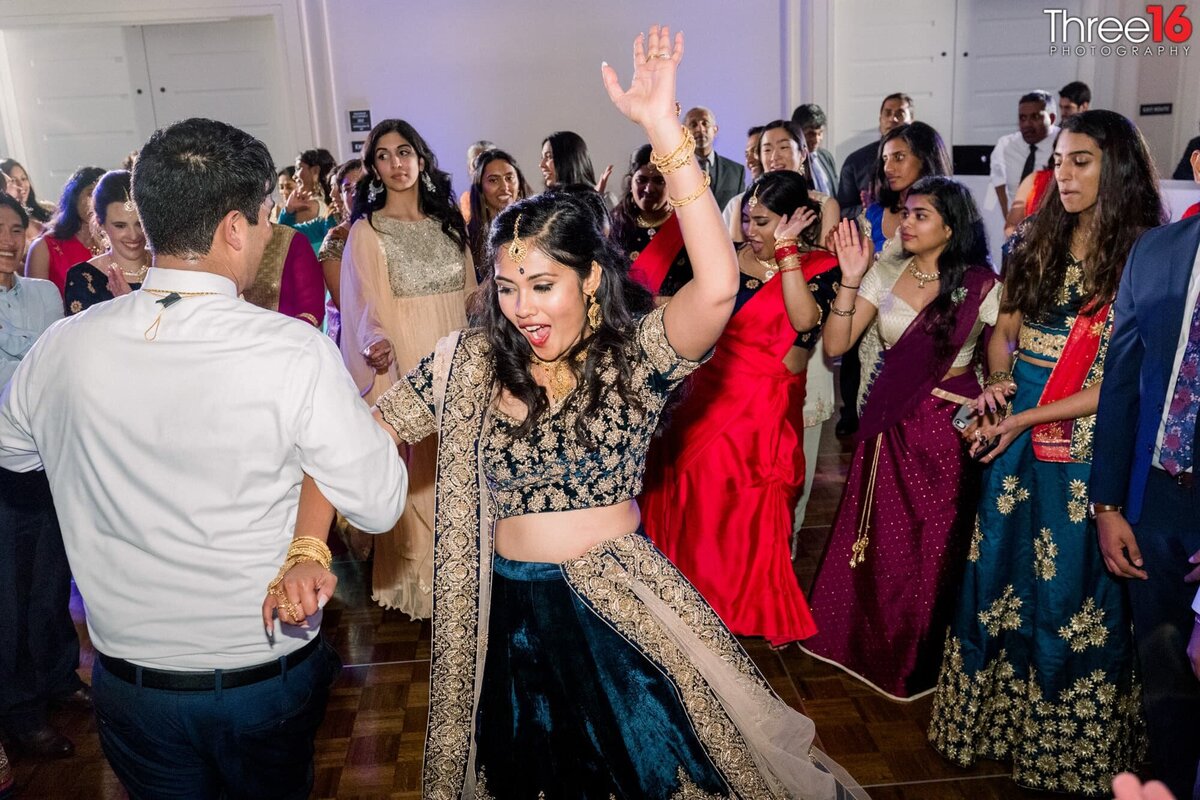 Bride and Groom dance together while wedding guests form a circle around them