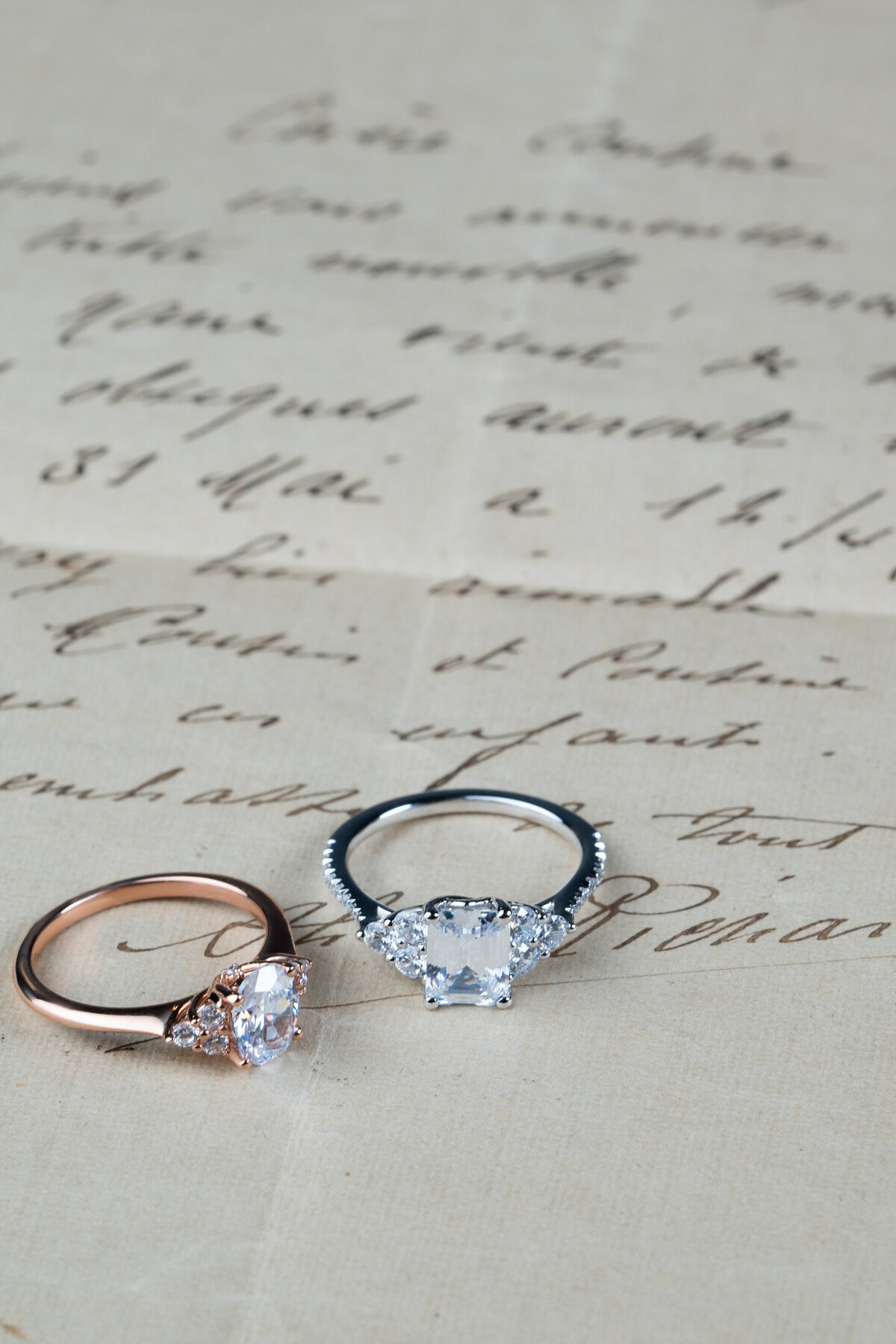 Delicate 3 stone accents flank these rose and white gold engagement rings