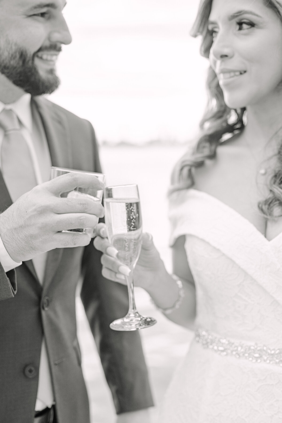 Bride and groom cheers champagne glasses