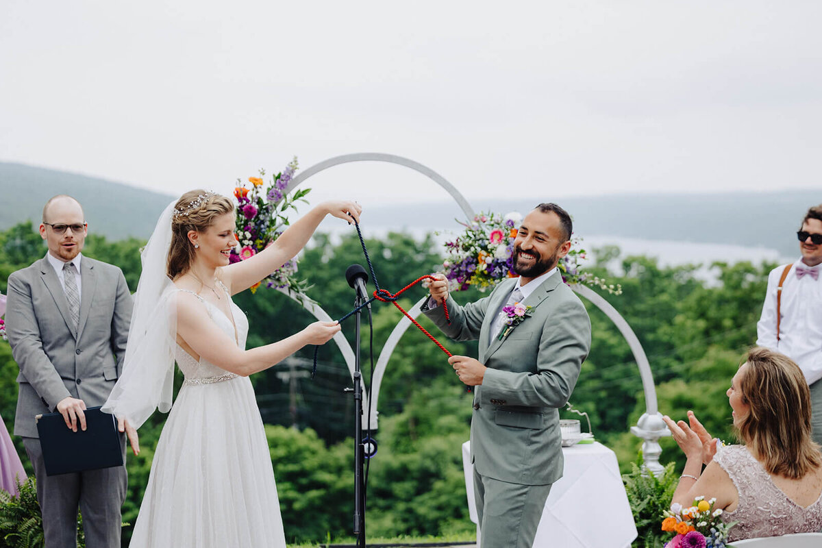 Bride and groom after knot unity ceremony overlooking Keuka Lake