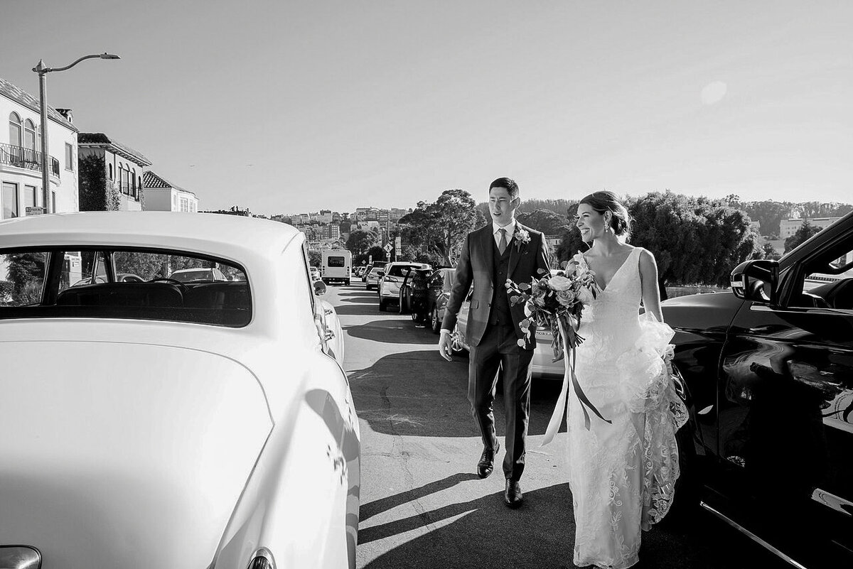 Bride and groom head to reception in classic car
