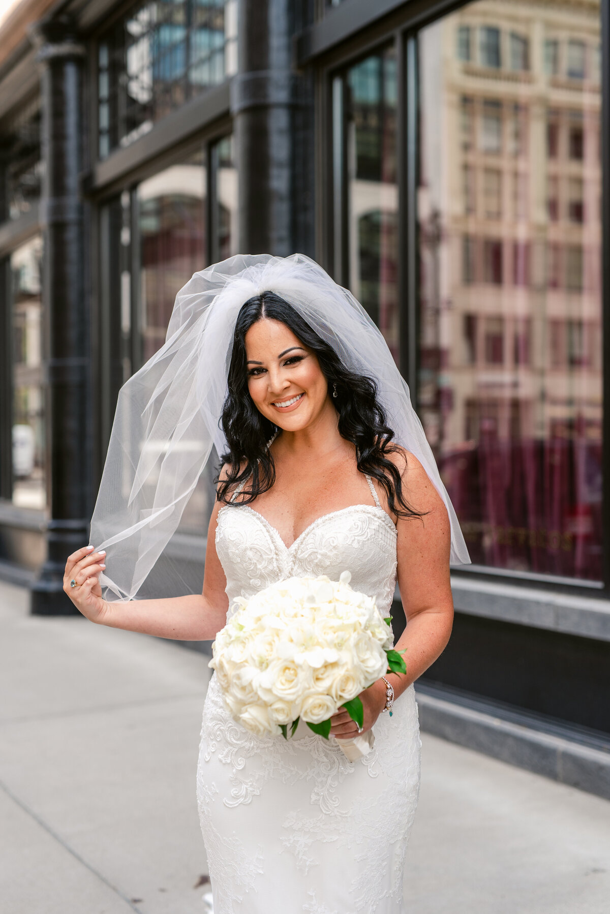 Bride standing outside Downtown Detroit posing for her bridal portraits.