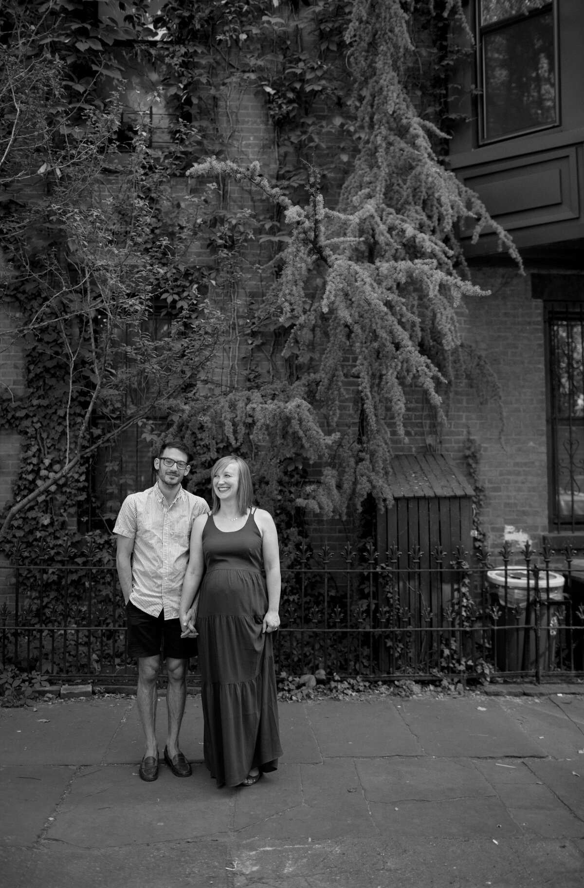 Couple pose in city street in Brooklyn.