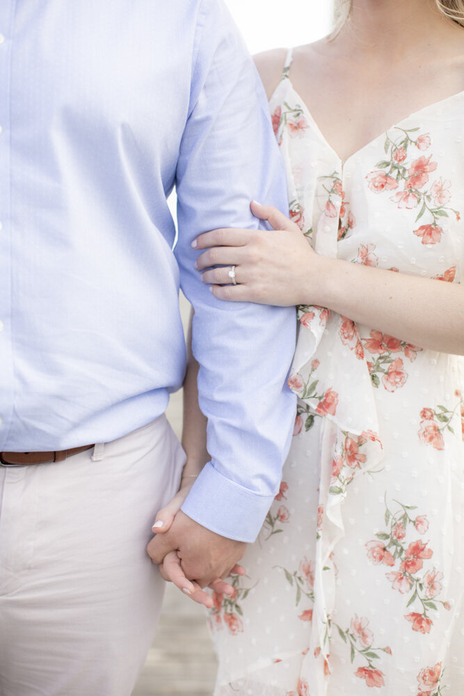 closeup of engaged couple holding hands for engagement portrait
