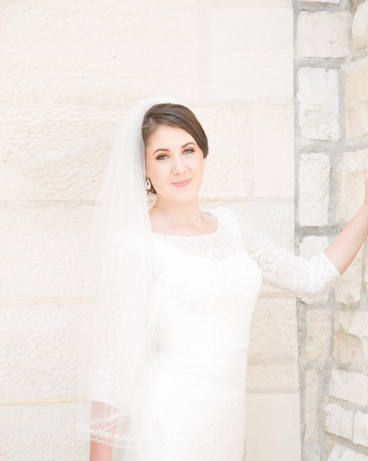 a bright softly lit bride in an alcove during her wedding photography session