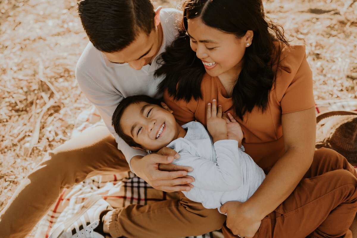 Man and woman play with their child