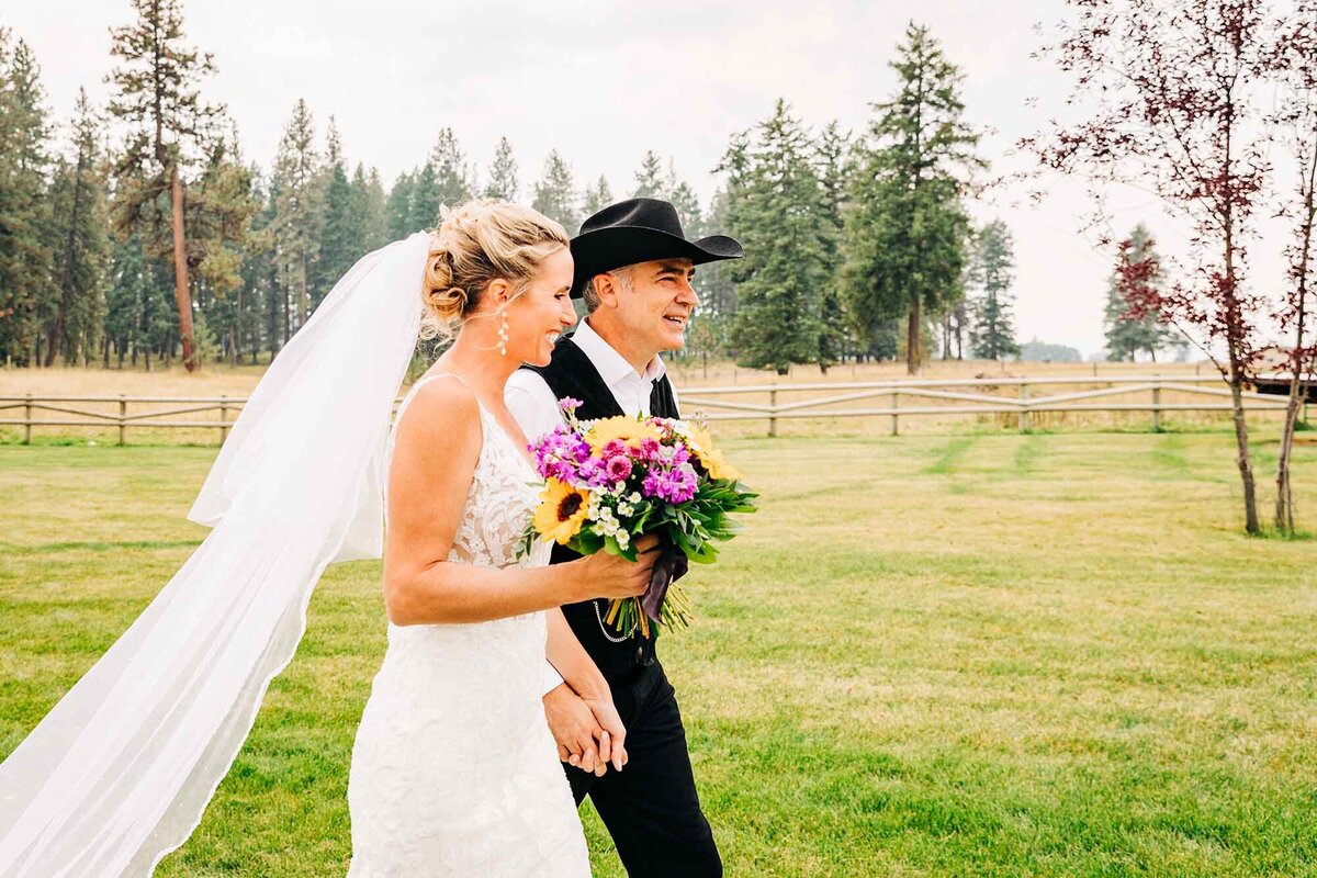 Bride and groom walking together at The Silver Knot, Ronan, MT