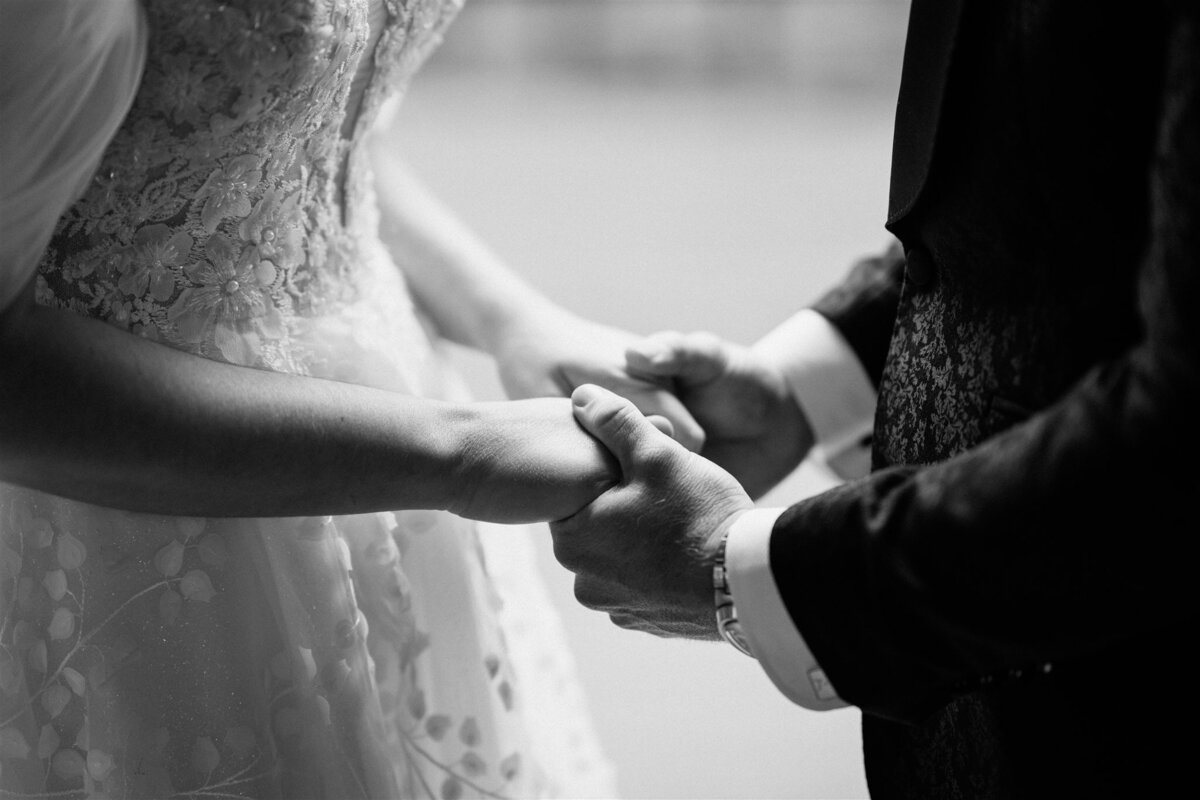 A couple stands lovingly at their ceremony, exchanging vows with heartfelt emotion.
