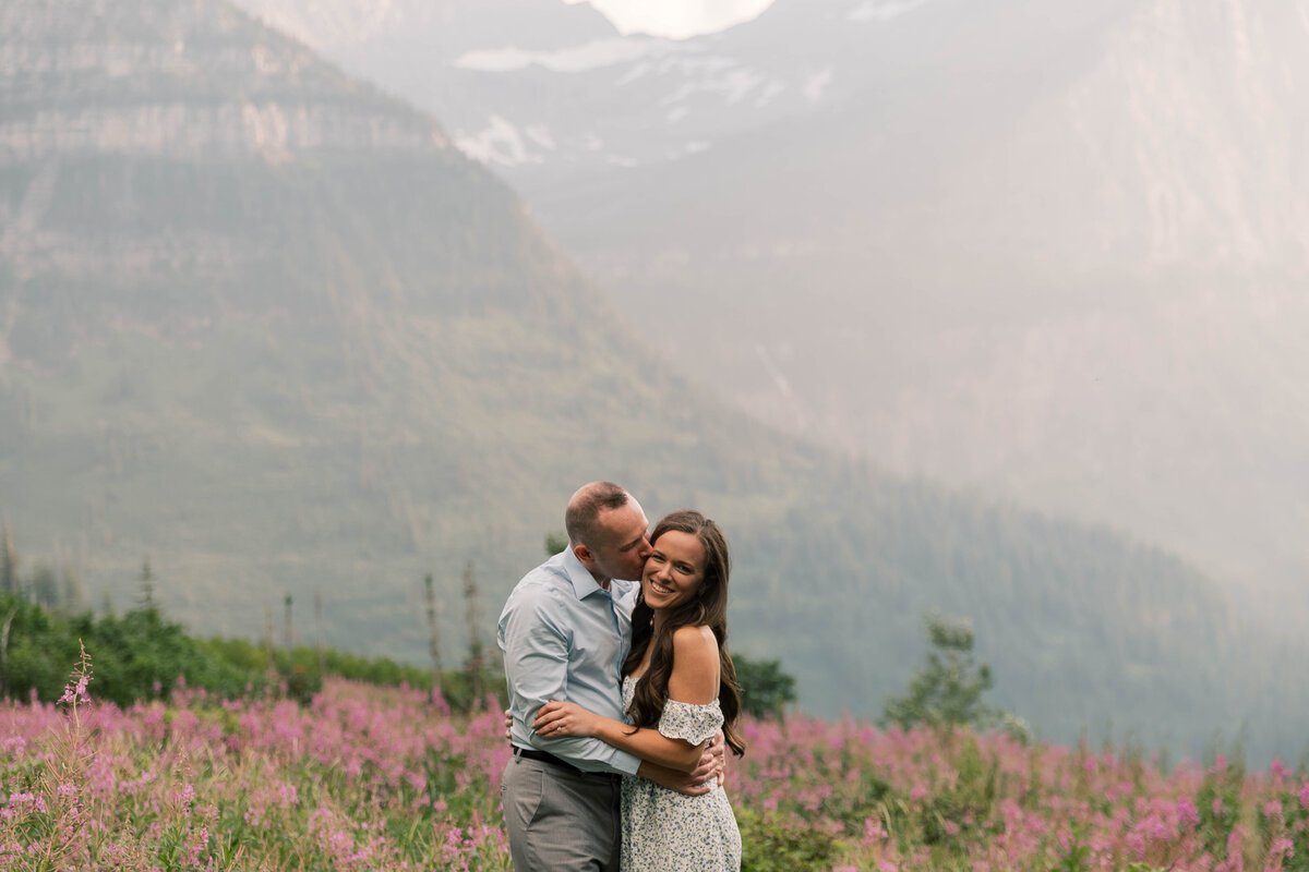 man kissing fiance on cheek