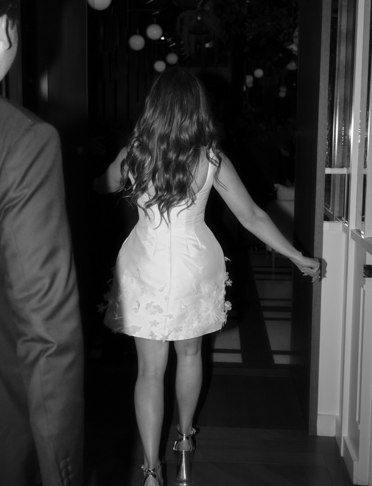 a bride enters her Shinola Hotel wedding reception in second bridal look, short dress