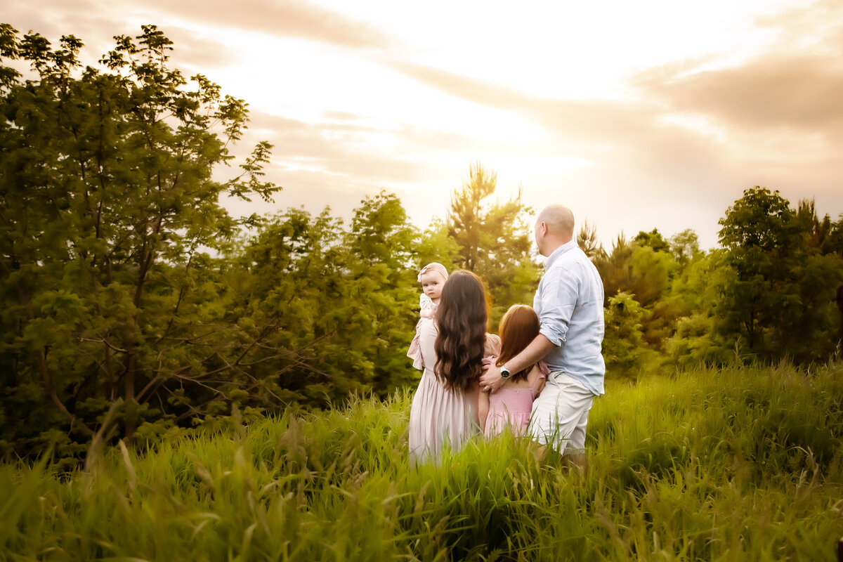 family snuggled in a field , Syracuse NY photography