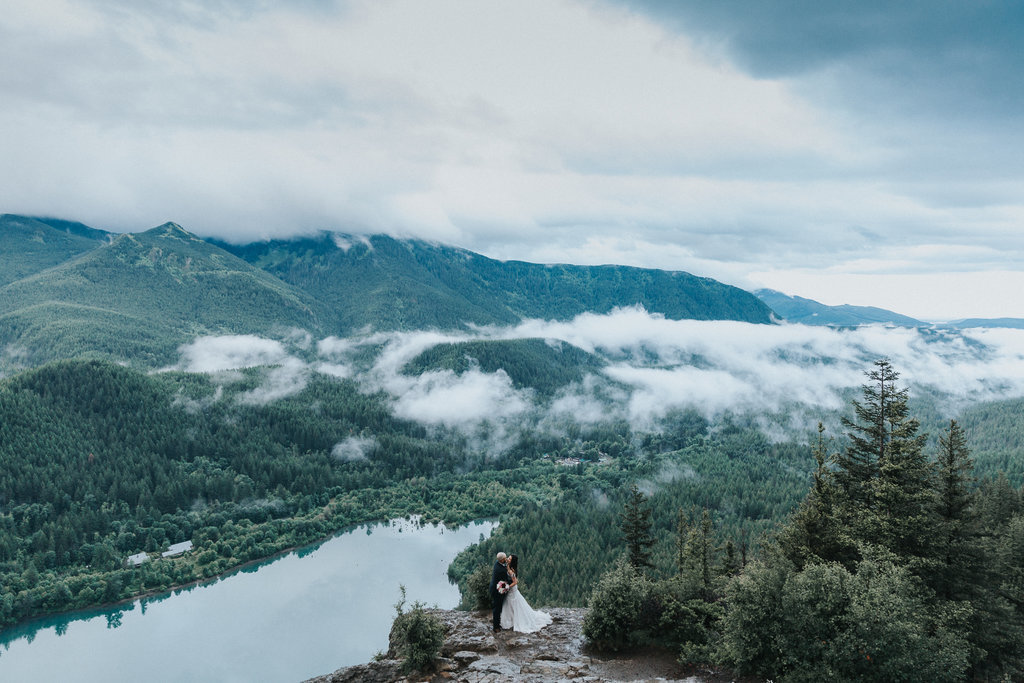 An elopement at Rattlesnake Ledge, a bride and groom embrace.