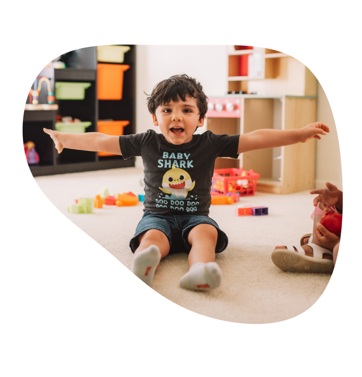 A toddler laughing and having fun at at Books & Blankets childcare & early learning in Elk Grove, CA.