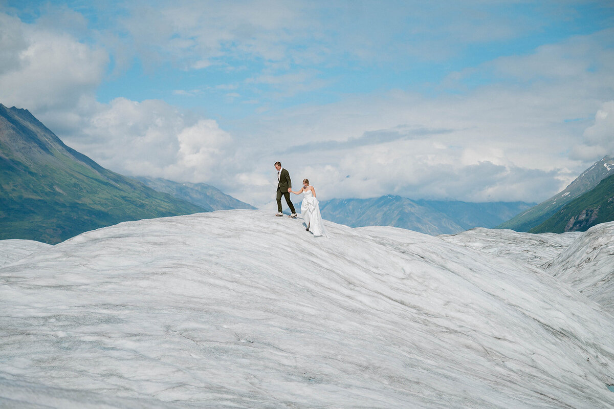 COuple stand on top of glacier
