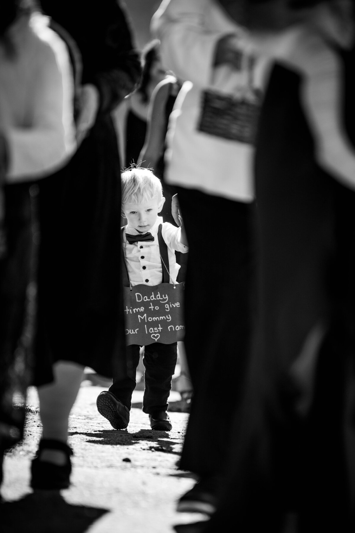 Boy holds sign at wedding