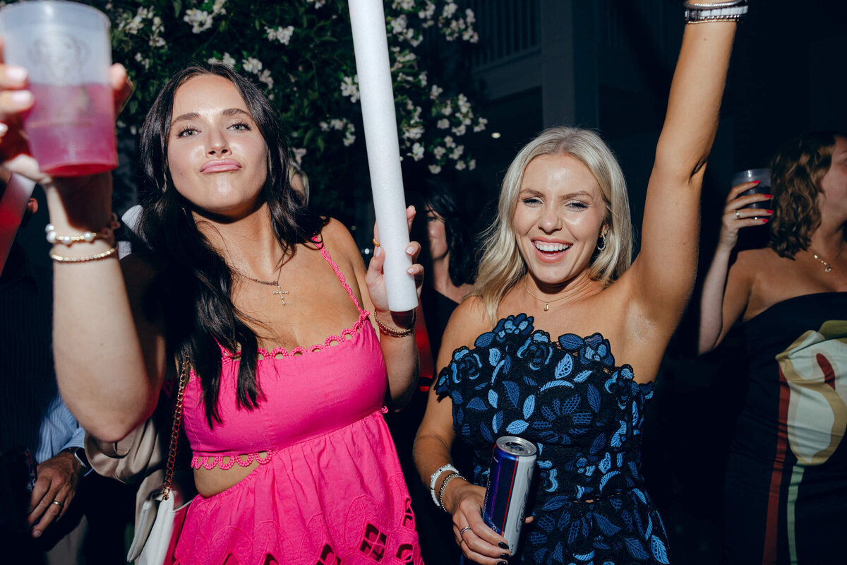 A wedding photo of guests dancing during the wedding reception